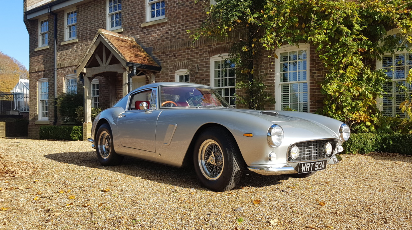 A grey Mirage GT parked outside of a home
